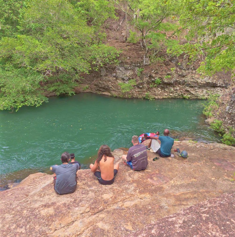 Family sitting on the rocks above the river